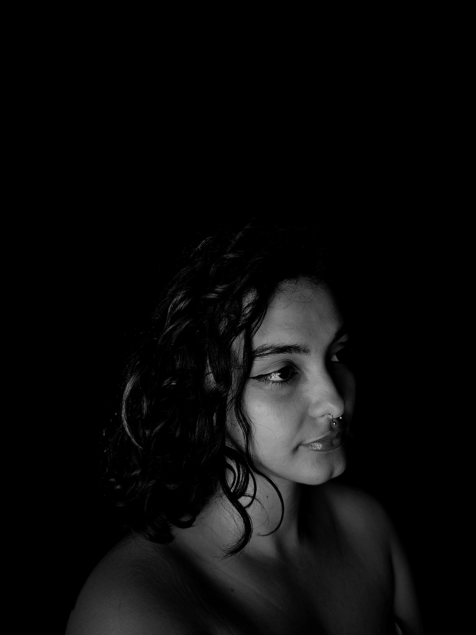 A dramatic black-and-white portrait with soft shadows