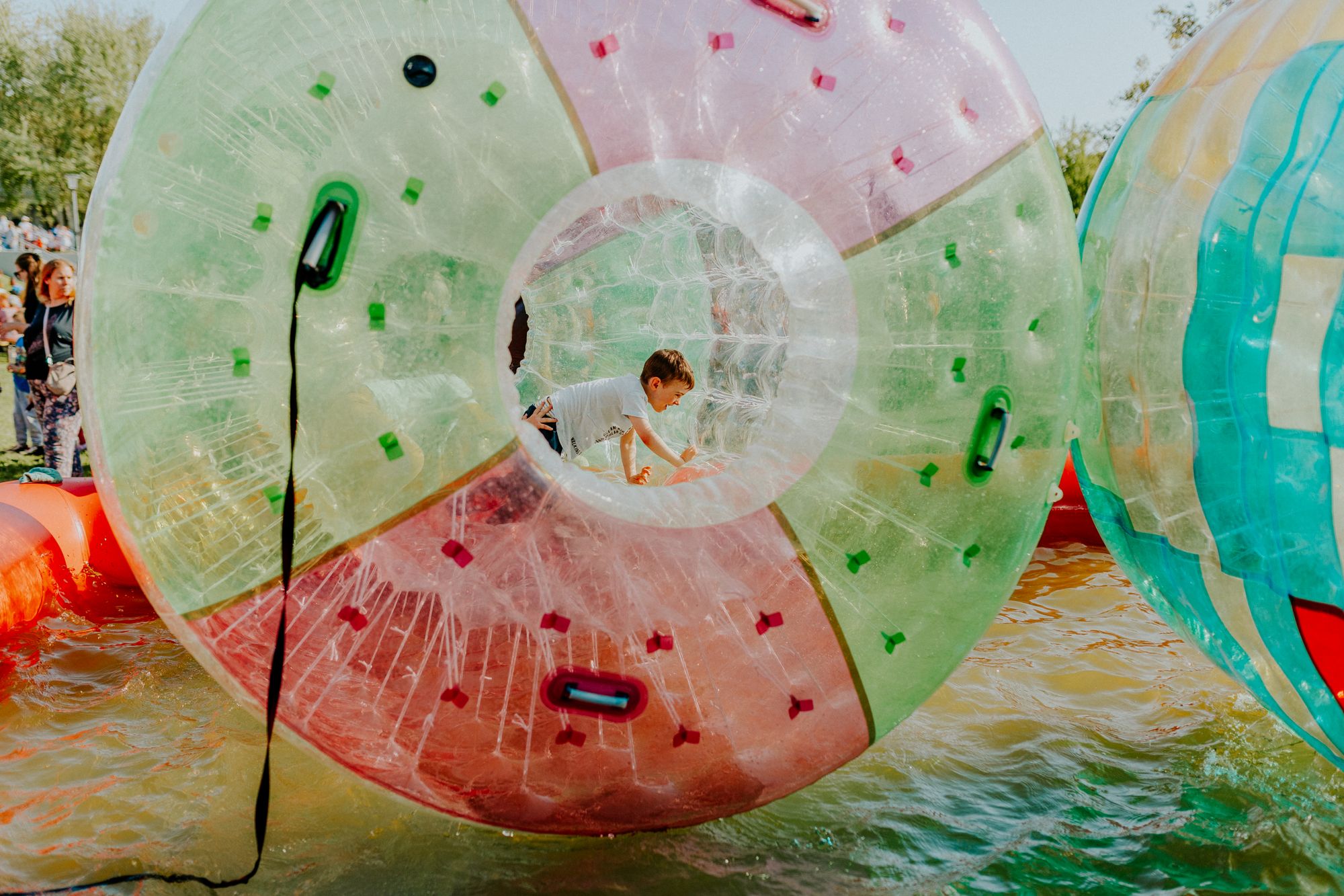 A child rolling inside a giant clear inflatable ball
