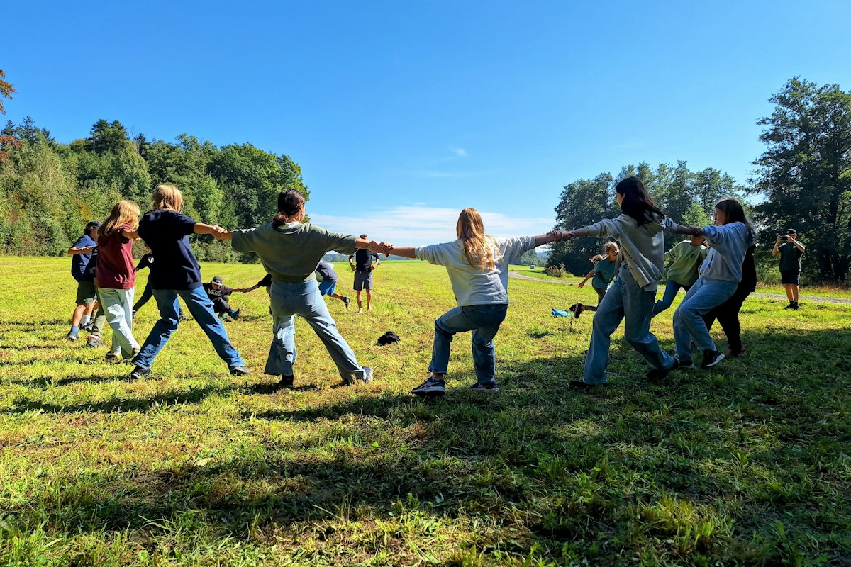 Coworkers playing a giant lawn game at a company event