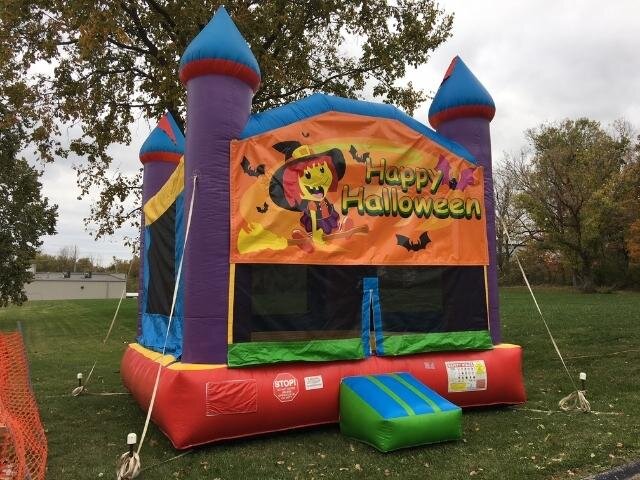A Happy Halloween bounce house with turrets