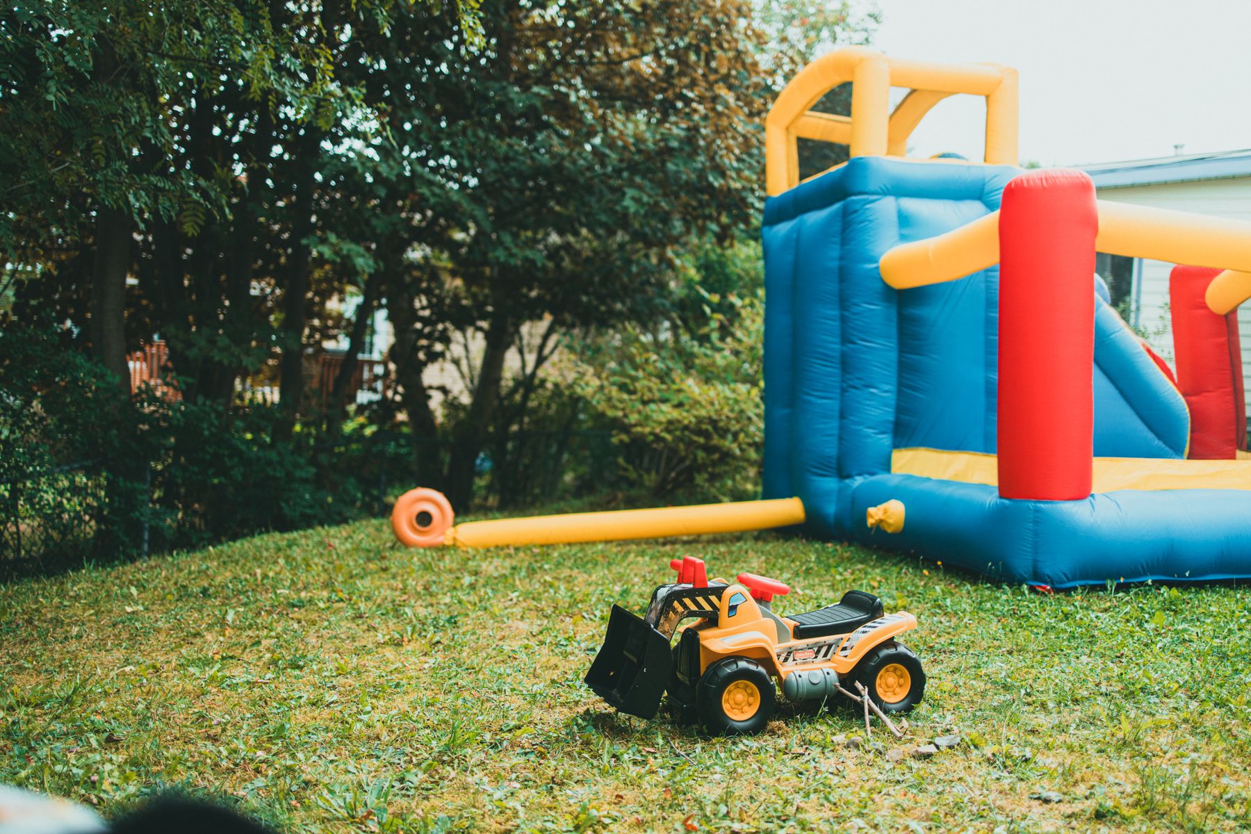 A bounce house and slide combo on a lawn
